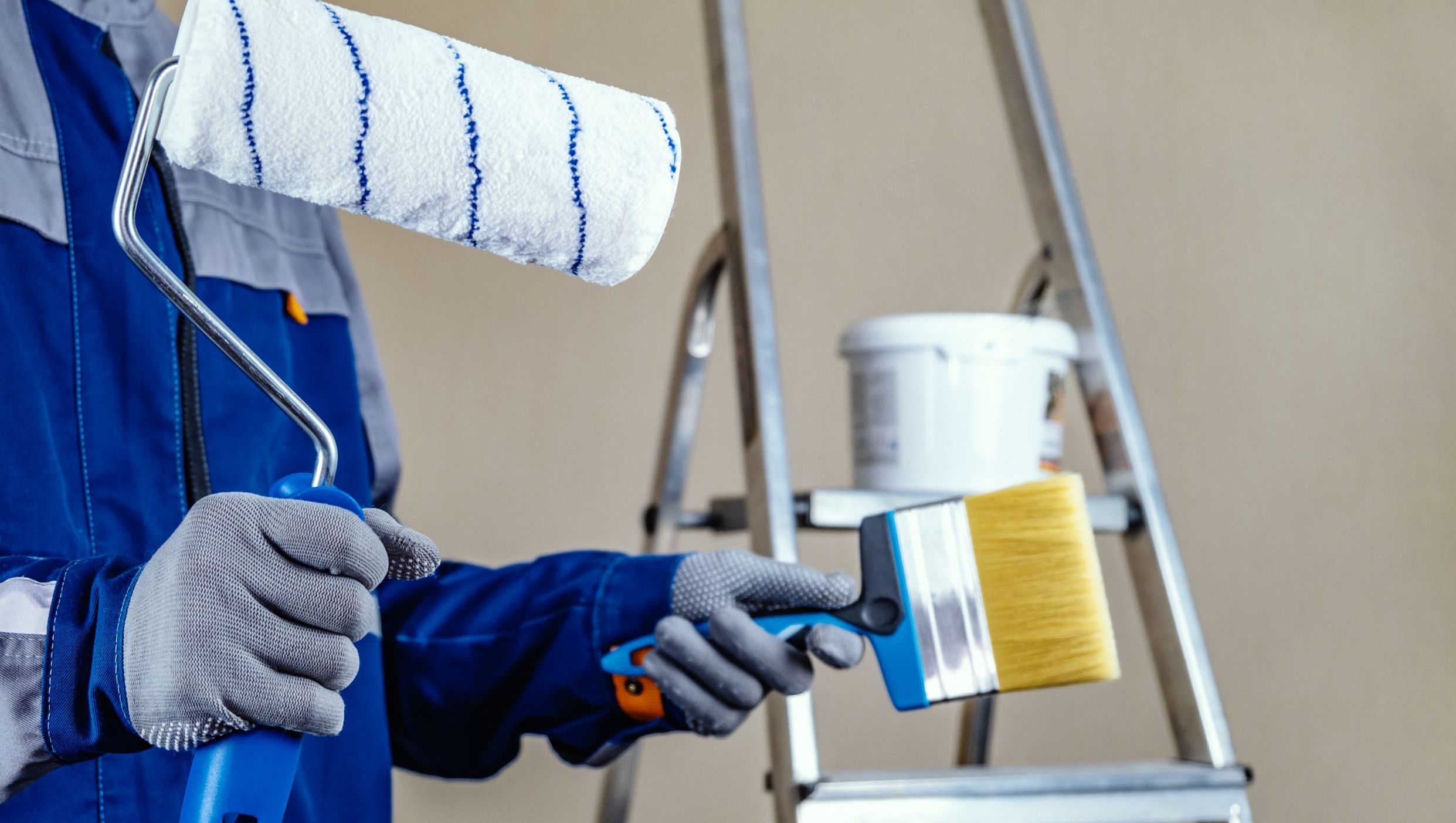 plaster painter is ready paint wall hands roller brush stepladder bucket paint background